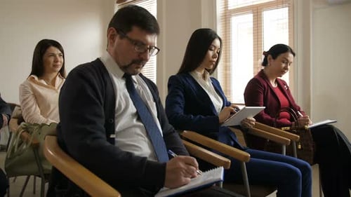 Diverse Group Attending Meeting in Bright Room