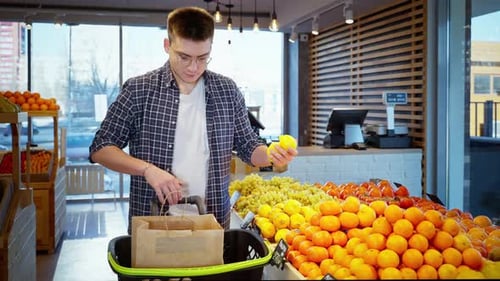 Man Shopper Buying Lemons at Greengrocery or Supermarket