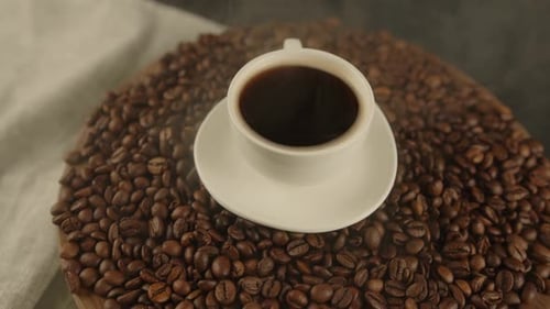 Coffee Cup Surrounded by Coffee Beans