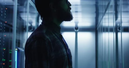 Man Walking Through a Server Room