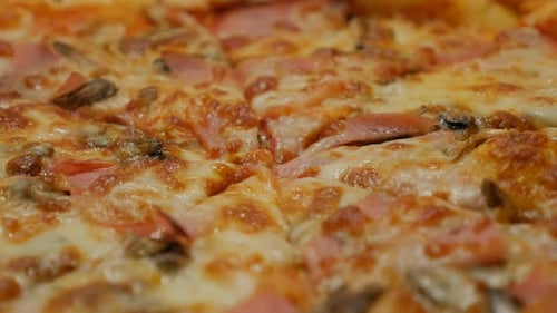 Tasty food Italian pizza surface with cheese and bacon close-up 4K 2160p 30fps UHD video - Texture