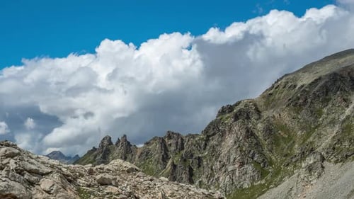 Puffy Clouds above rocky mountains