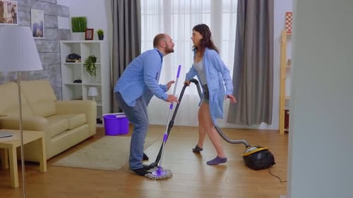 Couple Arguing During Housework Indoors
