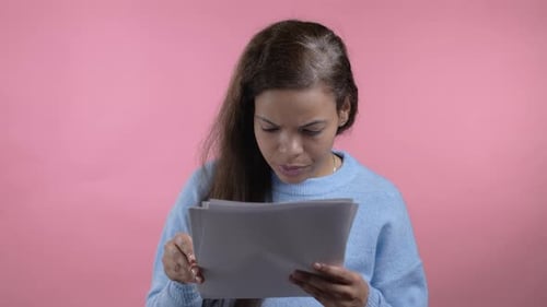 African Woman Holding Files Papers Isolated on Pink Background