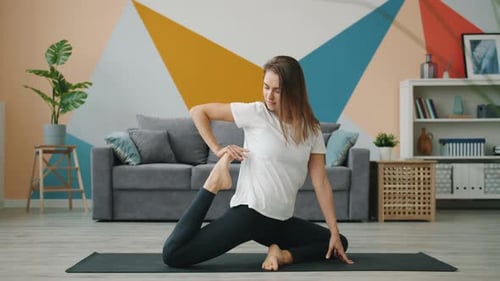 Woman Exercising, Stretching and Practicing Yoga at Home
