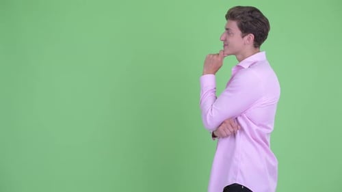 Profile View of Happy Young Handsome Businessman Thinking