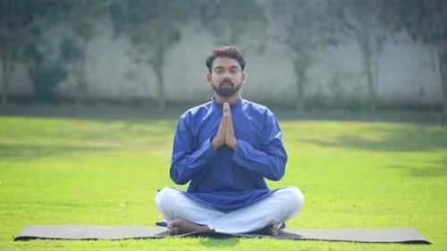 Man Meditating in Peaceful Rural Green Setting
