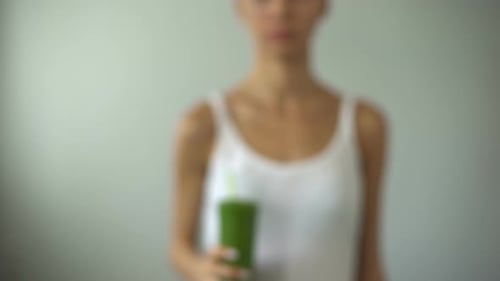 Girl Holding Green Smoothie for Weight Loss, Vegetable Juice, Healthy Diet