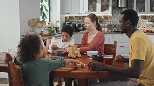 Family Breakfast with Children Playing with Toys