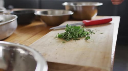 Chef Picks Fresh Herbs in Commercial Kitchen