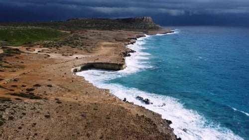 Ocean Waves Crash Against the Rocky Shore the Coastline of the Mediterranean Sea During a Storm