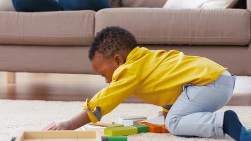 Child Playing with Colorful Wooden Blocks at Home