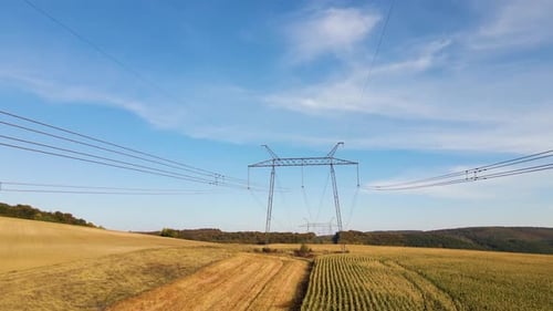Rural Landscape with Powerlines Under Blue Sky