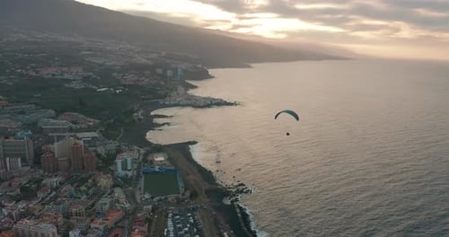 Flying with a Paraglider High in Sky