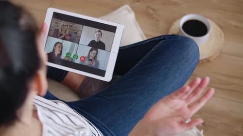 Woman Uses Tablet for Video Conference With Friends