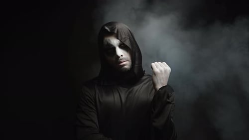 Man with Halloween Makeup in Hooded Black Robe