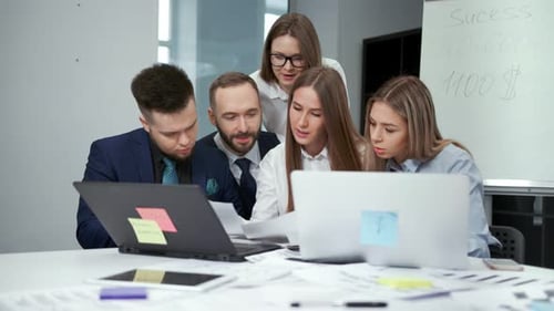 Female Teamleader Showing Paper Documents Colleagues Having Team Meeting Discussing Working