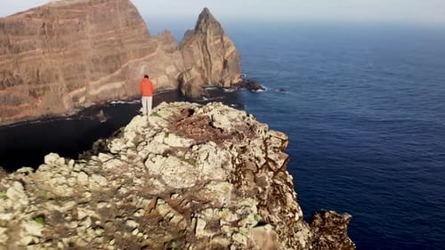 Man Standing on Rugged Ponta de Sao Lourenco Coastline , Madeira Island, Portugal