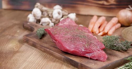 Raw Beef with Vegetables on Cutting Board