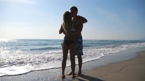 Romantic Couple Embracing on a Sunny Beach