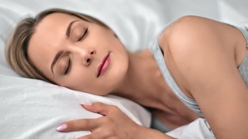 Woman Sleeping Peacefully in Bed at Home