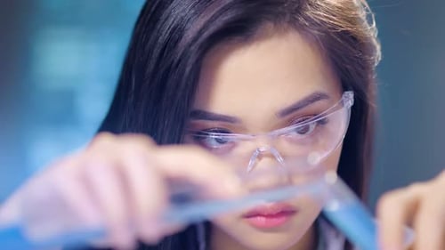 Woman Scientist Holding Test Tubes in Laboratory
