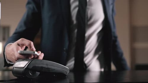 Guest in Hotel Paying Bill with Smartphone Via NFC Technology Businessman in Lobby Pay with Phone