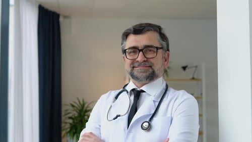 Smiling Male Doctor in Lab Coat with Stethoscope