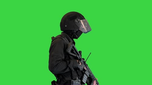 Swat Operator with Assault Rifle Walking on a Green Screen Chroma Key