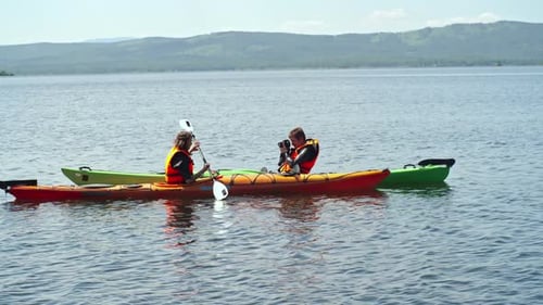 Friends Kayaking on a Peaceful Tropical Lake