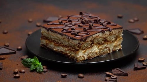Delicious Tiramisu Cake on Plate with Coffee Beans