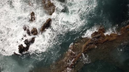 Ocean Waves Breaking on Volcanic Rocks