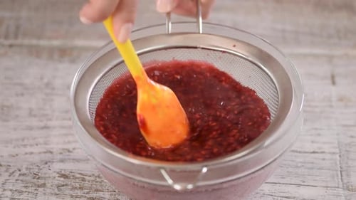 Mashing Raspberries Through Sieve