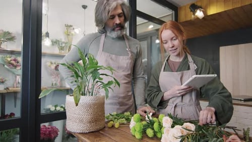 Flower Shop Workers Arranging Flowers Together