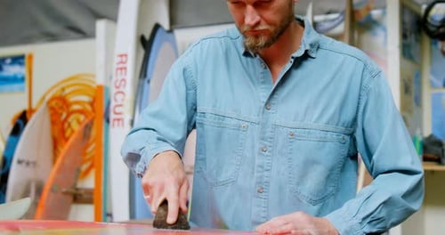 Man making surfboard 4k