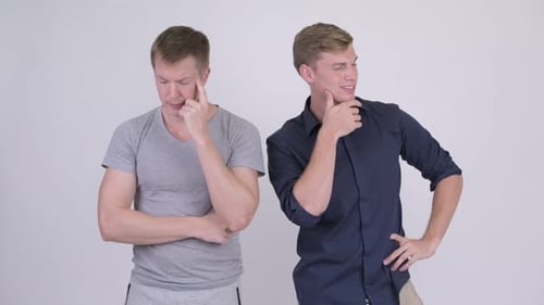 Scandinavian Man Thinking Seriously with Businessman Thinking Happily