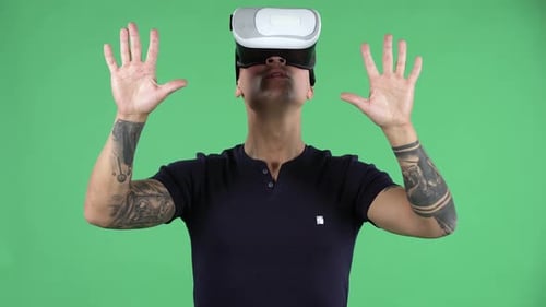 Portrait of a Handsome Young Guy with Virtual Reality Goggles. Green Screen.