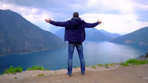Male Stands on the Edge of the Abyss and Looks at the Sea