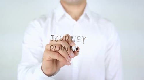 Man Writes Journey Planner on Glass