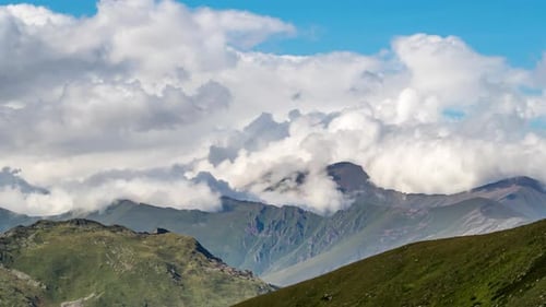 Puffy clouds over the mountains.