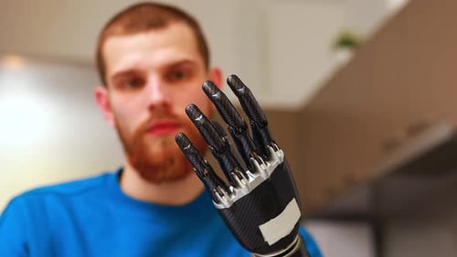Man Showing a Robotic Prosthetic Hand Close-up