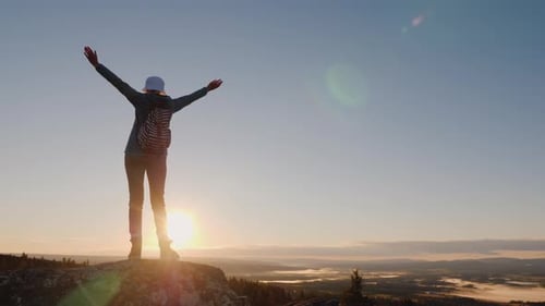 Crane Shot of A Successful Woman Traveler at the Top of the Mountain Raises Her Hands Up. Reach the