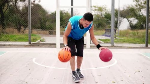 Closeup View of a Young Man Practicing Basketball on the Street Court