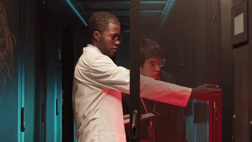 IT Specialists Inspecting Servers in Data Center