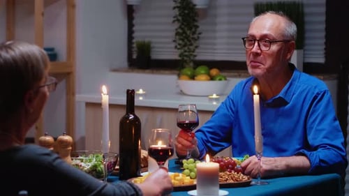 Senior Couple Enjoying Romantic Candlelit Dinner at Home
