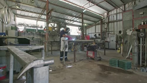 Metalworker Welding in an Industrial Workshop
