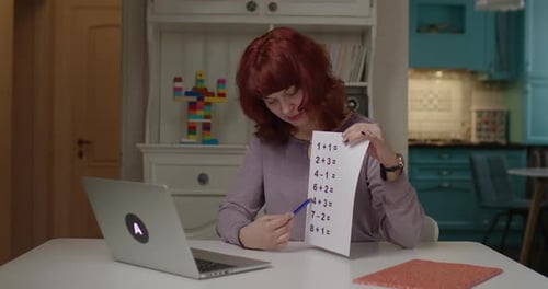 Woman Teaching Math Problems in Home Setting