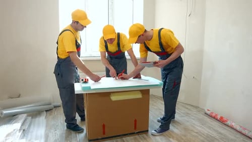 Construction Workers Reviewing Blueprints Indoors