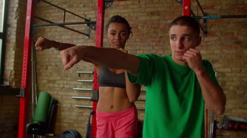 Man and Woman Practicing Boxing Punching Form