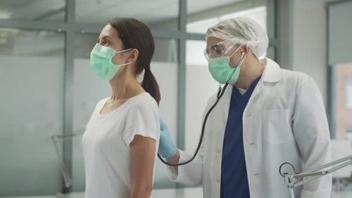 Doctor Listens to Patient's Lungs with Stethoscope